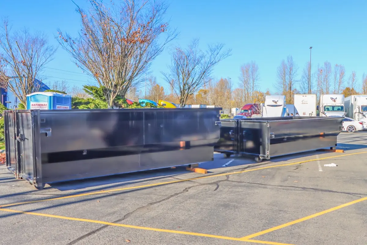 Professional dumpster rental service with roll-off container on residential driveway in New Brunswick